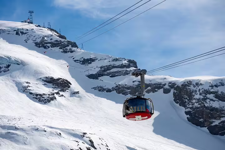 Ride the Titlis Rotair cable car over stunning snowy peaks for panoramic views on the Zurich Mt. Titlis discovery tour.