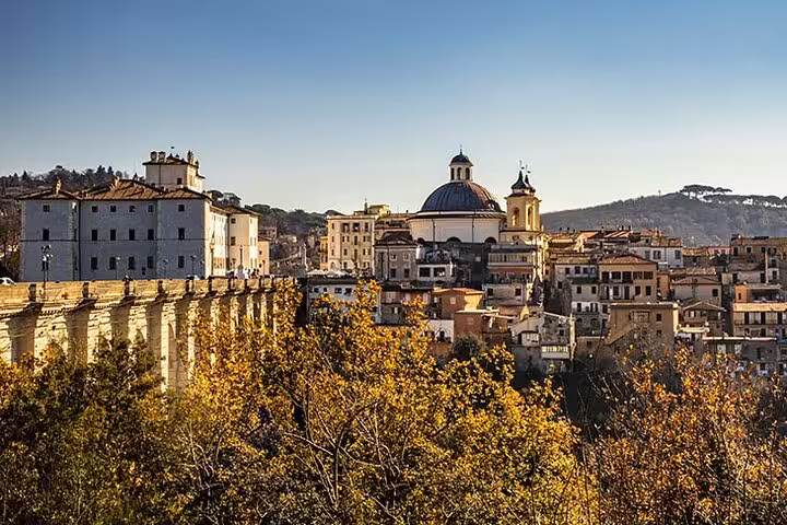 Picturesque townscape of Tivoli with iconic architecture and autumn foliage, ideal for Vespa adventures near Rome.