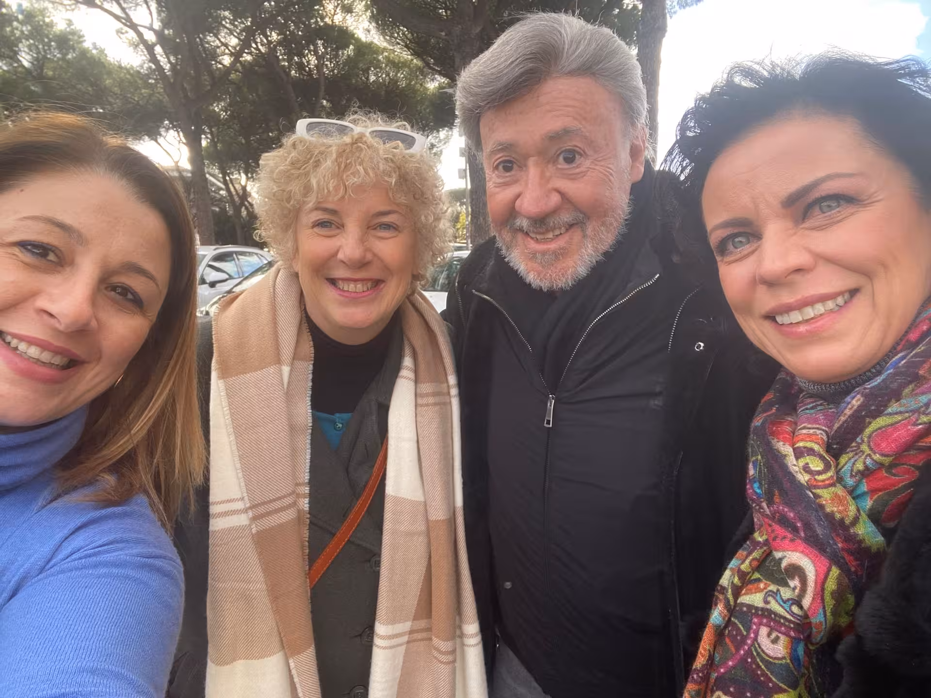 Group of smiling tourists enjoying a day out in Tivoli, perfect for a Fiat 500 vintage tour experience.
