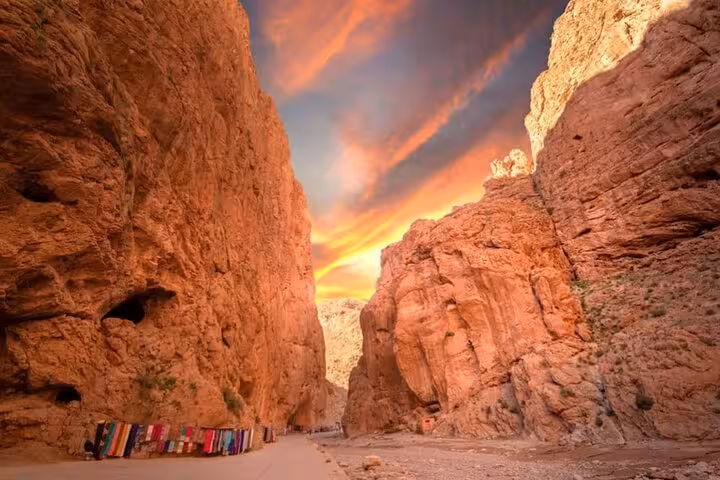 Sunset view of the dramatic Todra Gorge with its towering red cliffs, a highlight of the Fes to Marrakech desert tour.