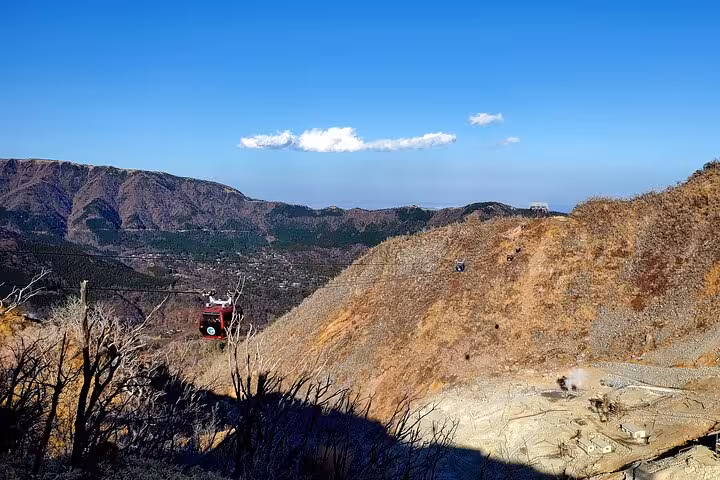 Scenic view from Tokyo to Hakone tour featuring a cable car ride over lush mountainous landscape.