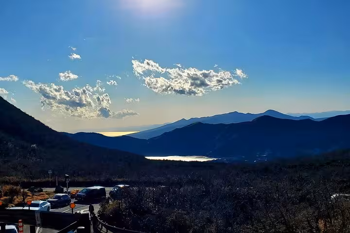 Scenic overlook of Hakone's mountainous landscape with lakes and vibrant skies on the Tokyo to Hakone guided tour.