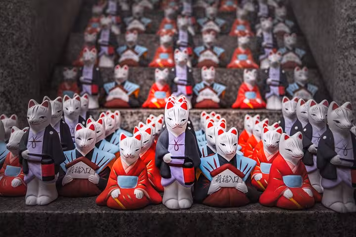 Colorful fox statues line the steps at a shrine on the Tokyo to Kamakura guided private tour, highlighting Japanese culture.