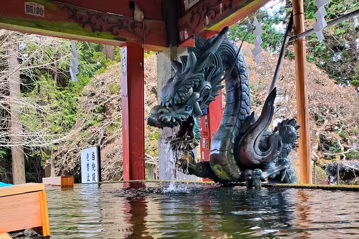 Intricate dragon fountain at a Shinto shrine in Japan, part of the Tokyo to Mt. Fuji customizable private tour.