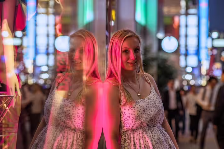 Night portrait in Tokyo with neon reflections, captured by a personal travel photographer on a city tour