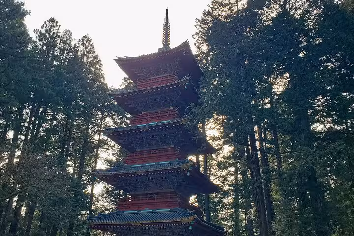 Five-story pagoda surrounded by lush trees in Nikko, featured on the Tokyo to Nikko English Guided Private Tour.