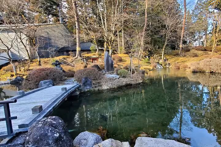 Experience the peaceful beauty of a Japanese garden with a reflective pond in Nikko on the guided Tokyo to Nikko tour.