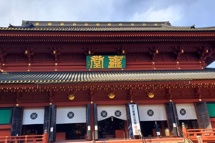 Traditional red temple facade with ornate golden details in Nikko, part of the Tokyo to Nikko private tour experience.