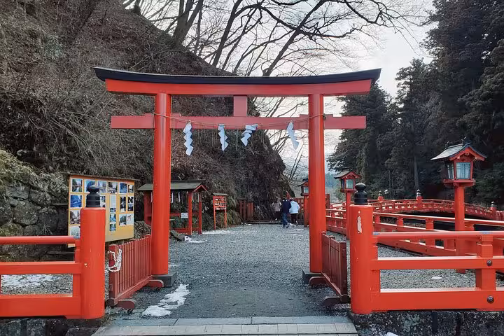 Vibrant red torii gate at a historic Nikko shrine, a must-see on the Tokyo to Nikko guided tour.