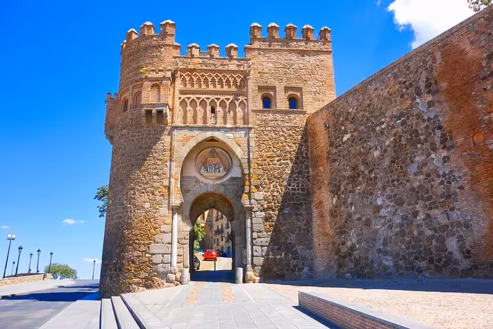 Ancient gate of Toledo, Spain, showcasing medieval architecture and historical significance on a bright day.