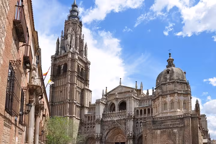 Majestic view of Toledo Cathedral under a bright blue sky, showcasing Gothic architecture on the Andalusia & Madrid tour.