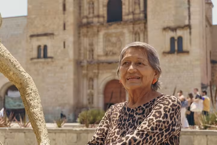 Smiling woman in front of a historic building in Toledo, Spain, capturing the essence of local culture and heritage.