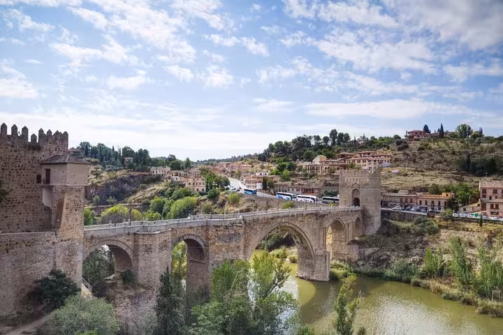 Scenic view of the ancient Alcántara Bridge in Toledo, a highlight of the day trip from Madrid with optional activities.