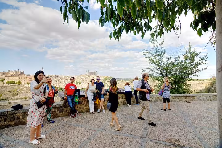 Tourists enjoy panoramic views of Toledo's historic skyline on a guided day trip from Madrid.