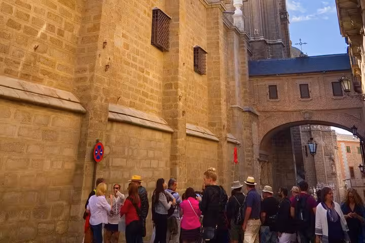 Tourists explore the ancient stone streets and architecture of Toledo during a guided half-day tour from Madrid.