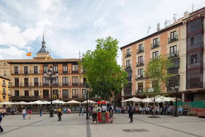 Toledo main square with cafes and historic buildings, visited on a private half-day Toledo tour by minivan