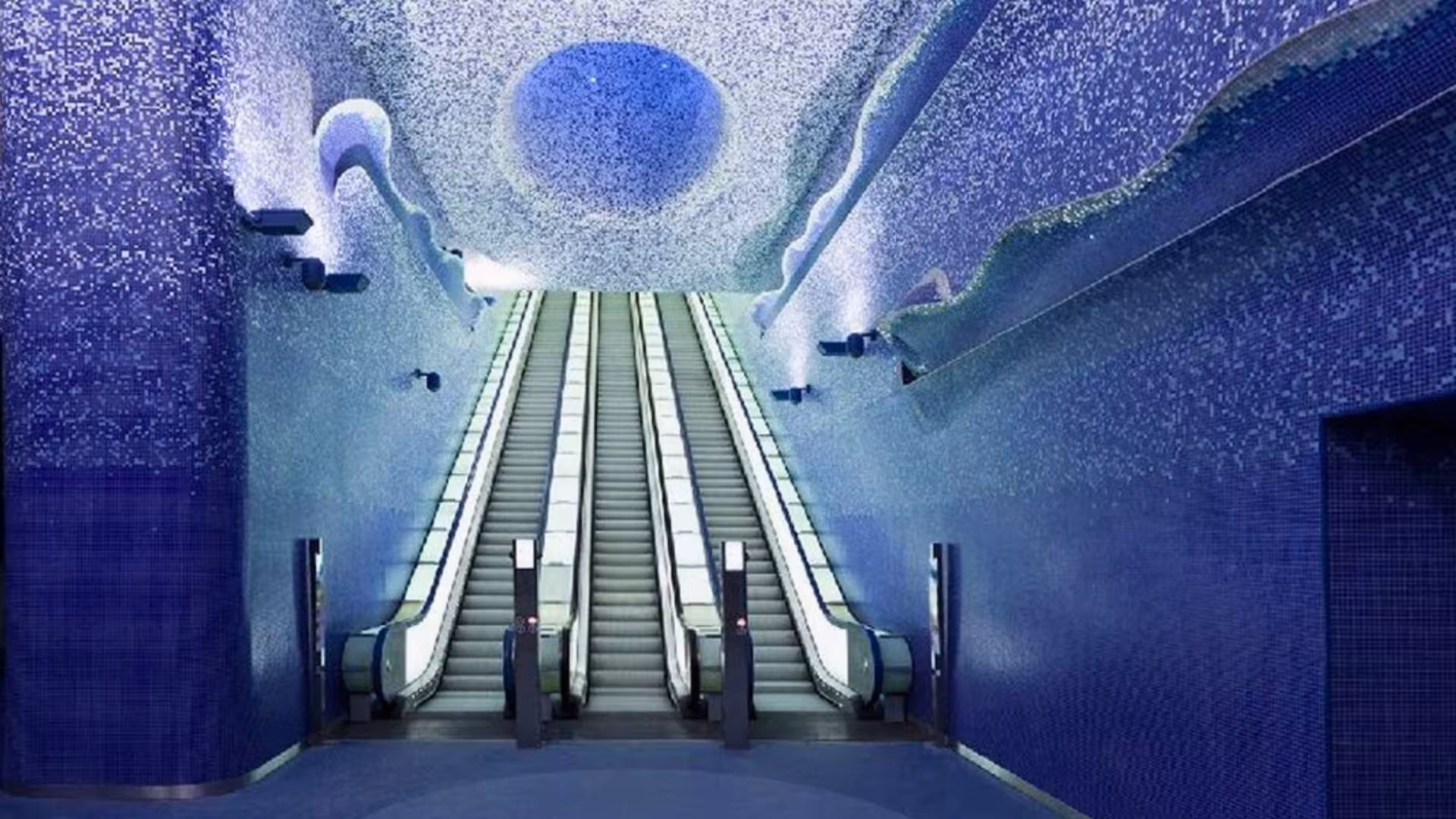 Bright escalators against a blue mosaic backdrop at Toledo metro station, a highlight of Naples' artists' tube tour.