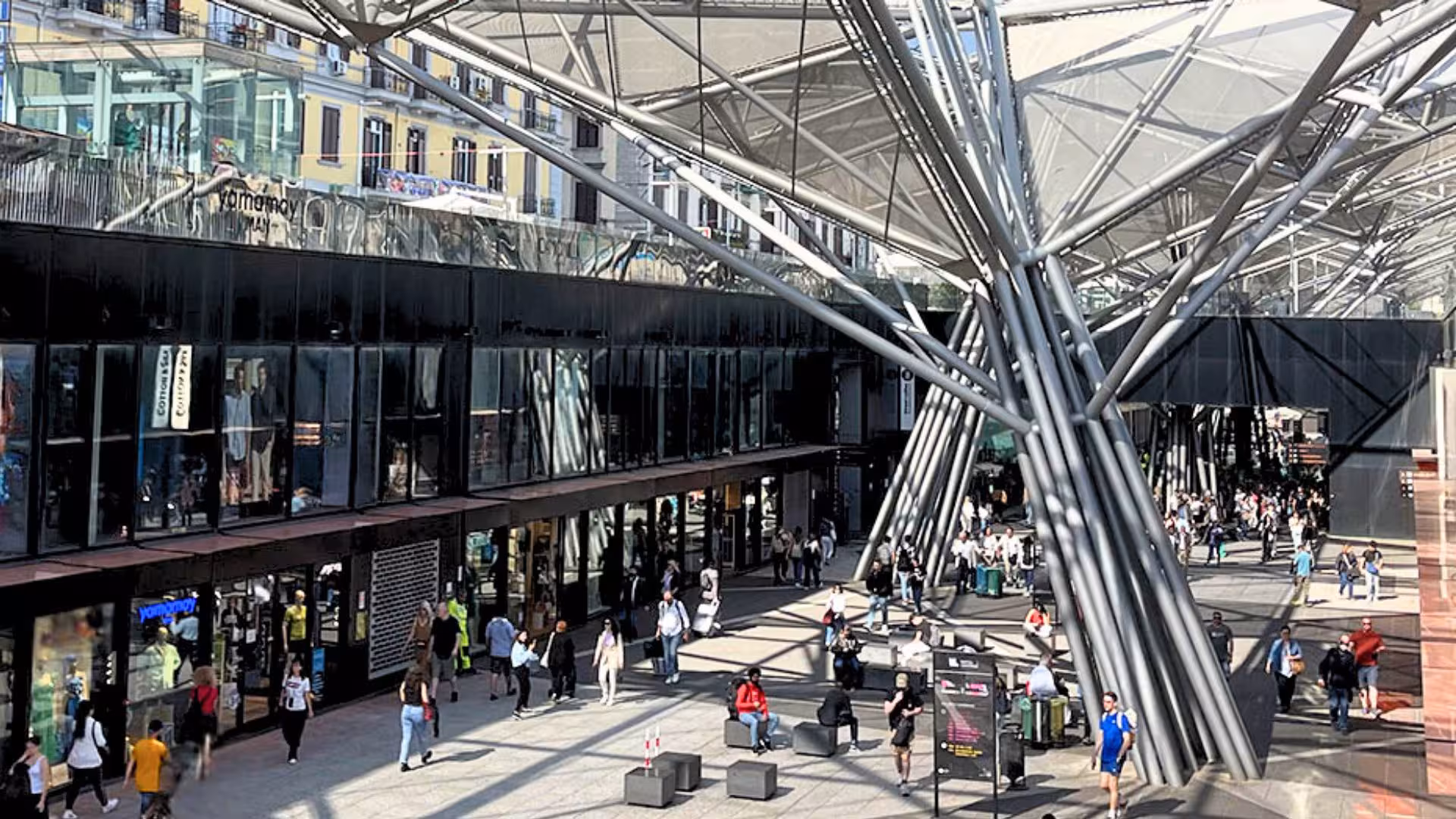Modern architectural design at Toledo metro station entrance, bustling with visitors on the Naples artist tube tour.