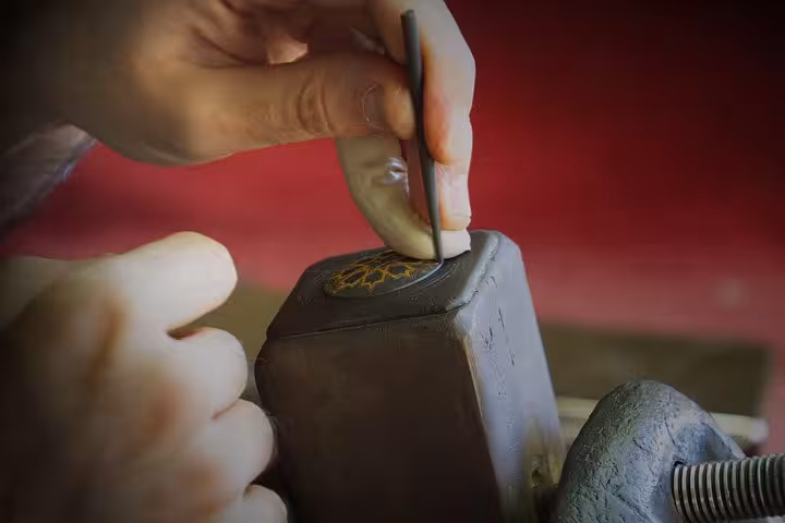Close-up of traditional craftsmanship in Toledo, highlighting intricate metalwork skills on a historic tour.