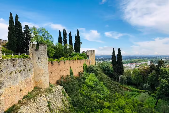 Historic Tomar castle and lush landscape on a private day tour exploring the Knights Templar heritage in Portugal.