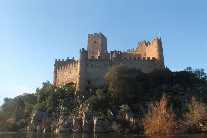 Majestic Tomar castle stands atop a rocky hill, showcasing the rich history of the Knights Templar on a private guided tour.