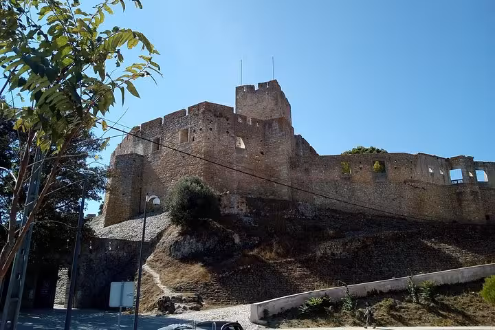 Visit Tomar Castle's ancient stone walls on the Private Tour of 1 to 8 Templars, showcasing rich medieval history.