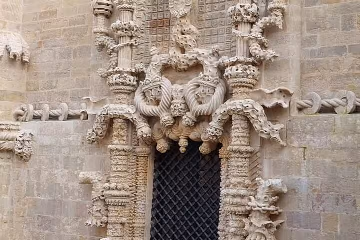 Intricate Manueline architecture at the Convent of Christ, showcasing elaborate stone carvings in Tomar, Portugal.