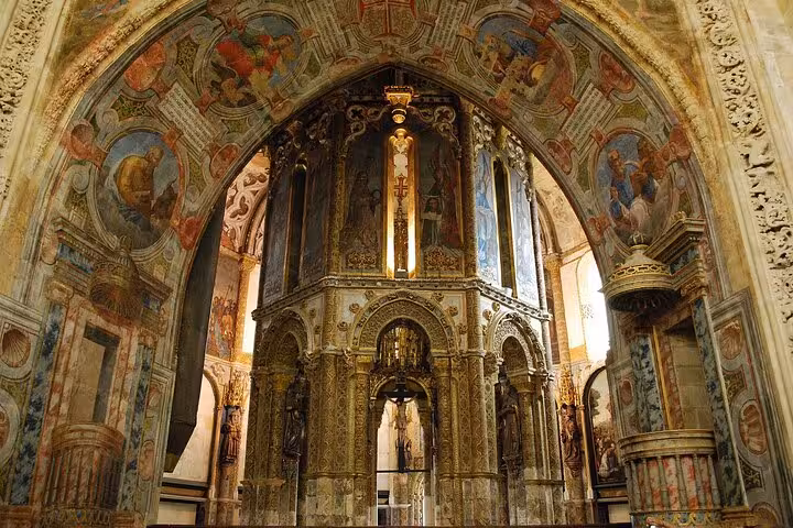 Discover the stunning ornate interiors of Tomar's Convent of Christ, showcasing intricate medieval frescoes.