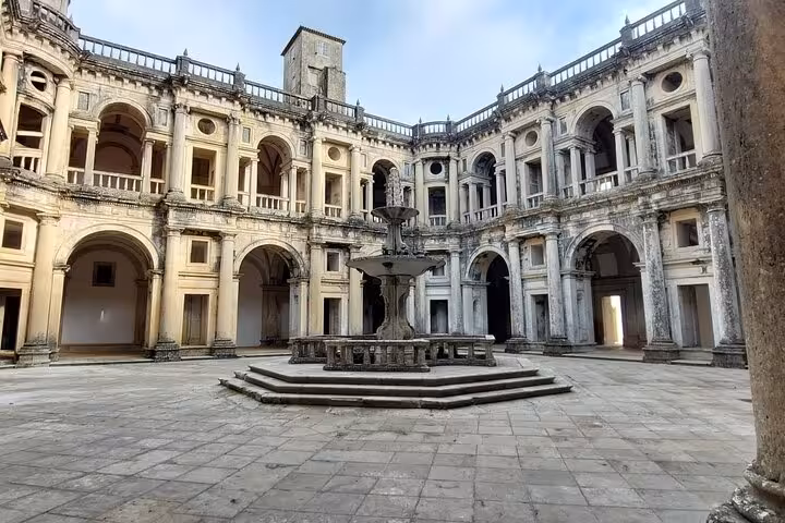 Explore the stunning architecture of the Convent of Christ's courtyard on a private walking tour in Tomar.
