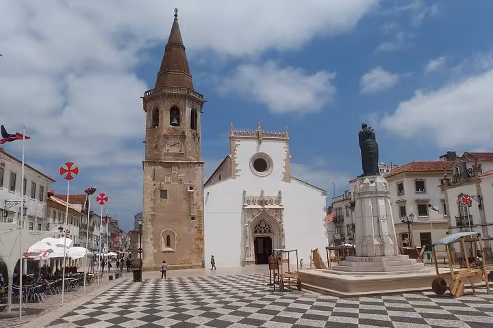 Explore Tomar's historic main square featuring the 12th-century Church of Saint John the Baptist and iconic statue.
