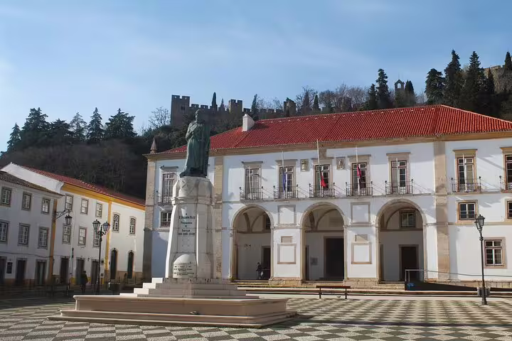 Historic square in Tomar with a statue and medieval architecture, showcasing Knights Templar heritage on a private guided tour.