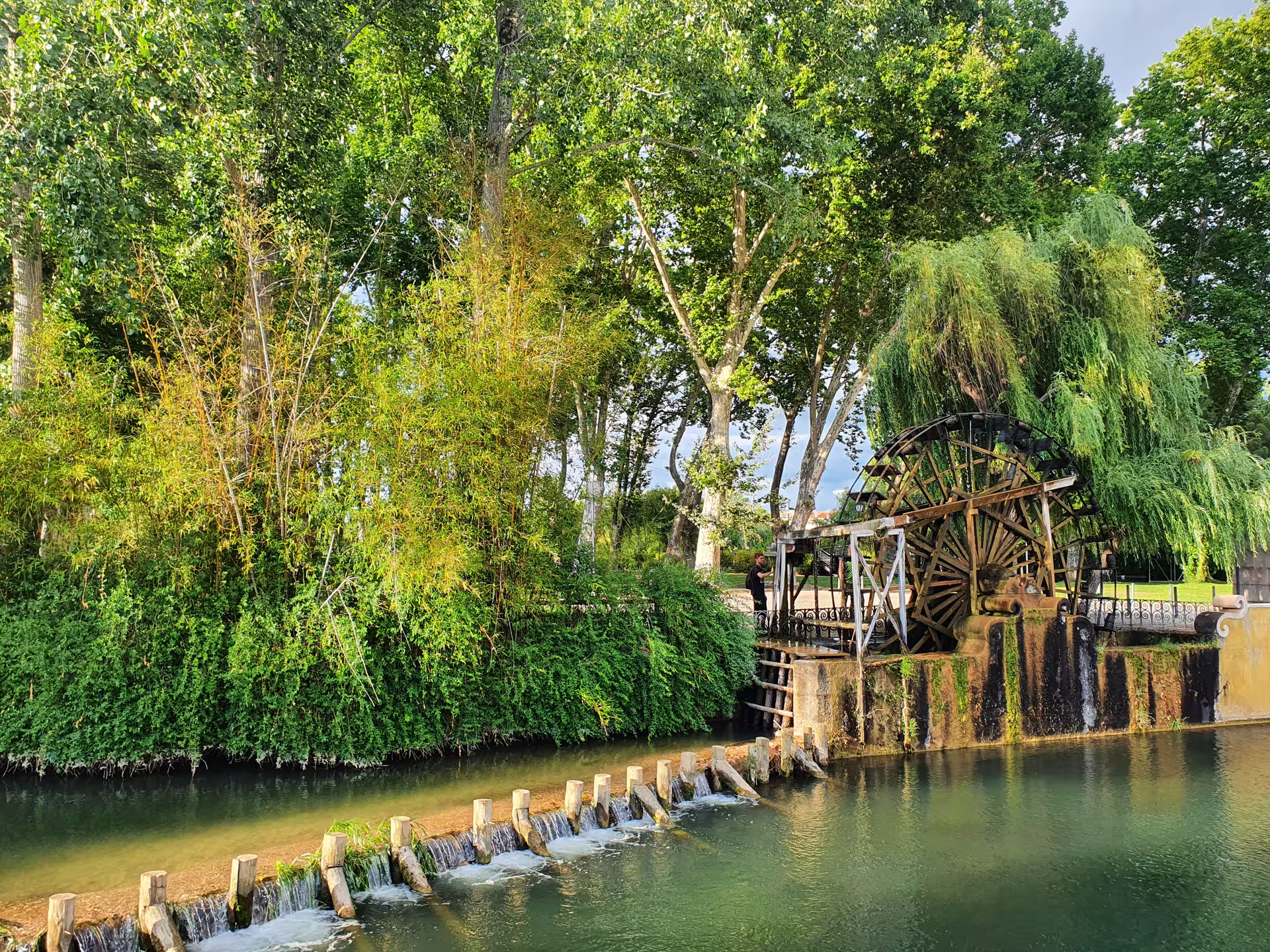 Scenic view of a historic watermill surrounded by lush greenery on the Tomar Knights Templar full-day private tour from Lisbon.