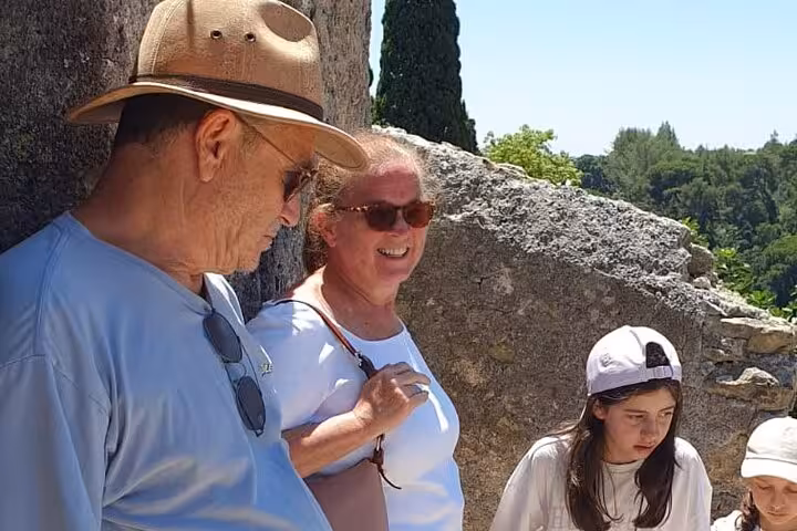 Visitors admire scenic views and ancient ruins during a local-led tour in Tomar, Portugal.