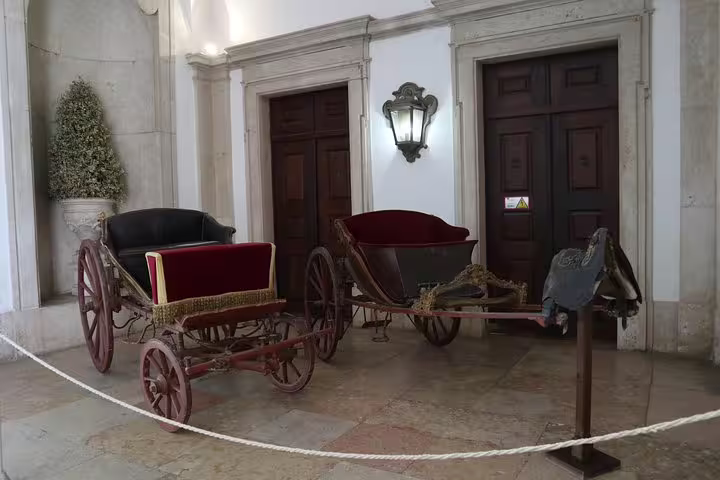 Vintage carriages on display in Mafra, a highlight of the Tomar and Mafra Small Group Tour from Lisbon.