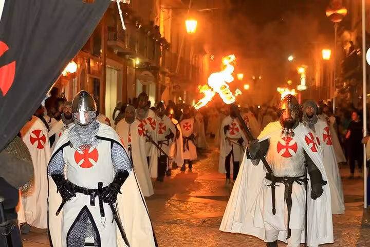 Experience a lively reenactment of medieval knights in Tomar, highlighting the town's rich historical and cultural heritage.