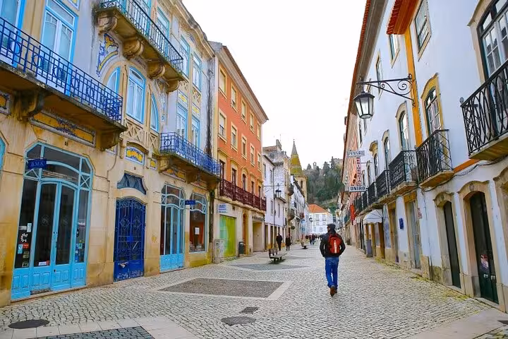 Charming street in Tomar's historic center, lined with colorful buildings, ideal for a private walking tour.