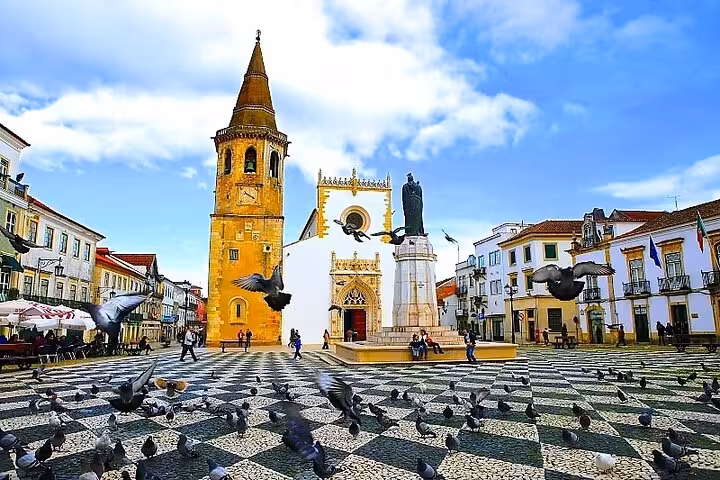 Vibrant town square in Tomar features a historic bell tower and bustling atmosphere perfect for a private walking tour.