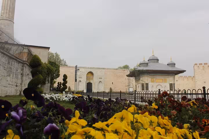 Topkapi Palace courtyard gardens with colorful flowers on Istanbul Old City full-day tour with lunch