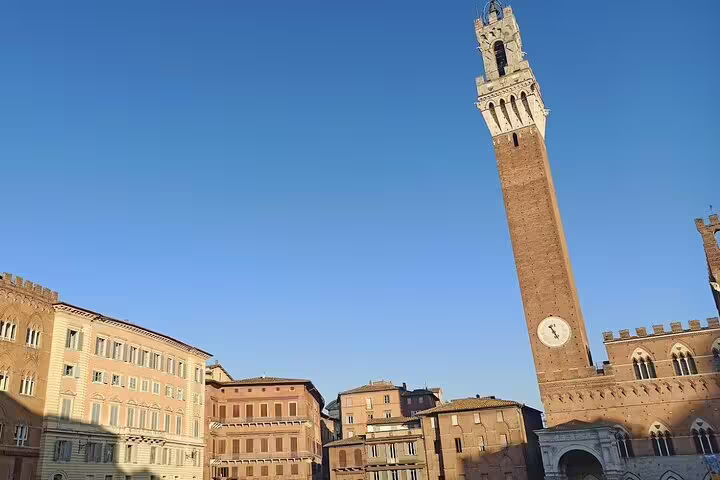 Torre del Mangia tower rising above Piazza del Campo in Siena, a highlight of Discover Tuscany and Chianti wine tours