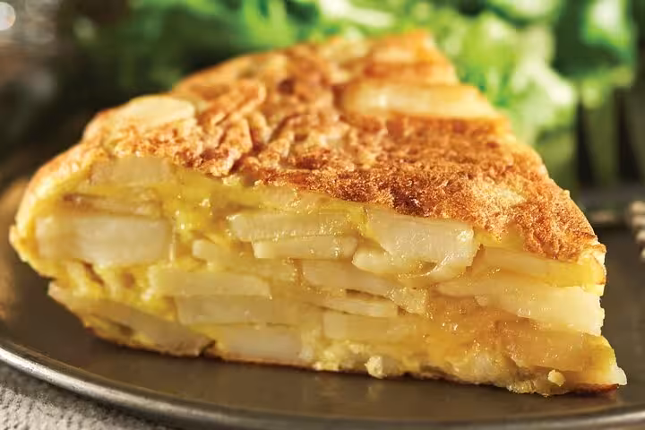 Traditional Spanish tortilla de patatas slice on the Gràcia Catalan food tour in Barcelona.