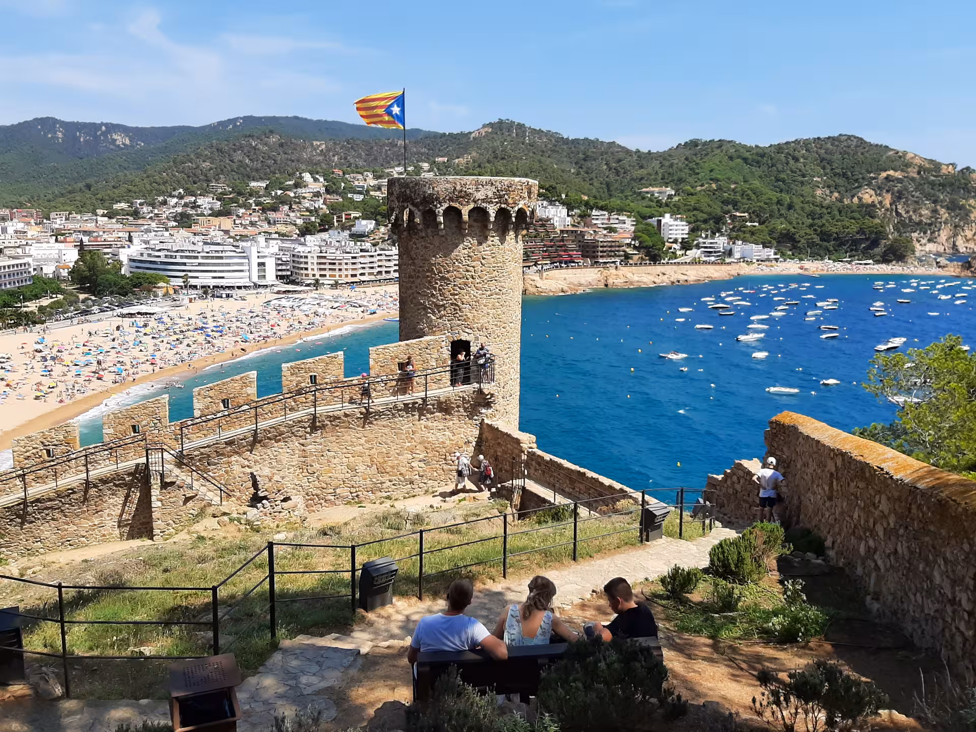 Medieval Tossa de Mar fortress viewpoint on Costa Brava tour from Barcelona, beach and boats in bay