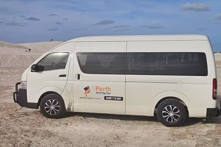 Tour van parked in a scenic desert landscape, ready for the 2 Days One Night Tour at Pink Lake and Pinnacles.