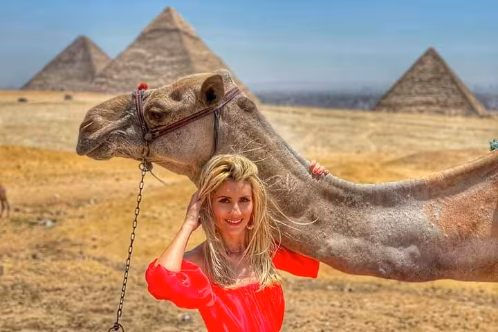 Tourist with camel at Giza Pyramids, Cairo day tour package with desert photo stop and guided visit