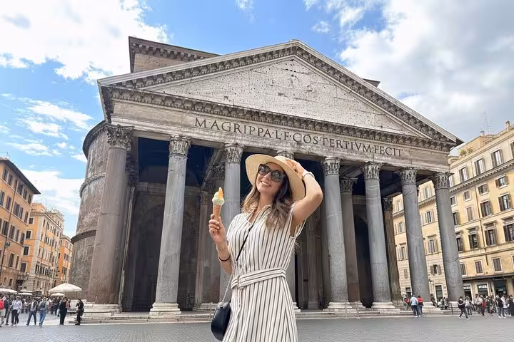 Tourist enjoying gelato in front of the iconic Pantheon in Rome during a Trastevere food and wine tour.