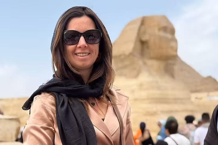 Smiling tourist at the Great Sphinx of Giza, a highlight of the Giza Pyramids Saqqara and Memphis day tour