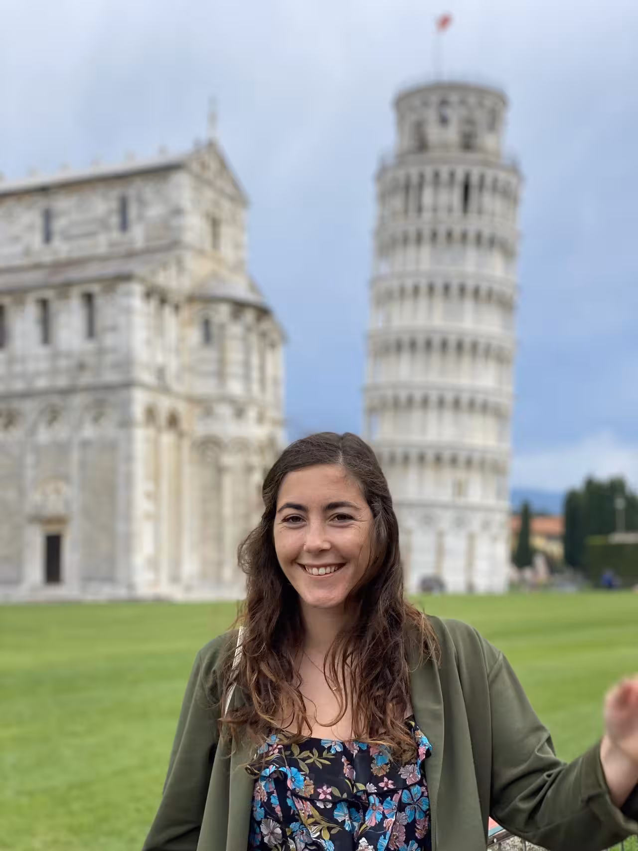 Smiling tourist in front of the Leaning Tower of Pisa during private half-day tour from Florence.