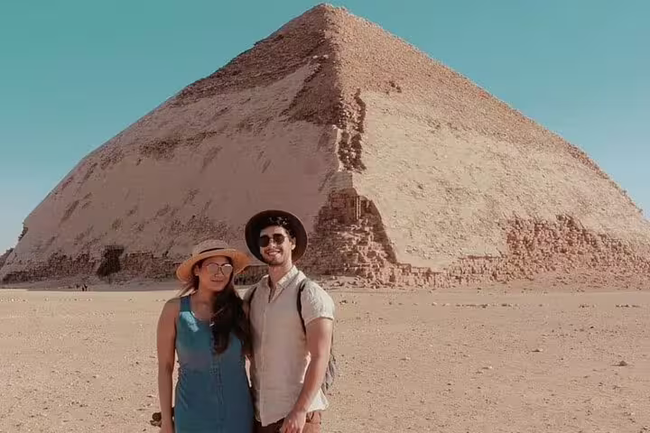 Tourists posing by Dahshur Bent Pyramid on Cairo luxury day tour visiting Giza, Memphis and Saqqara