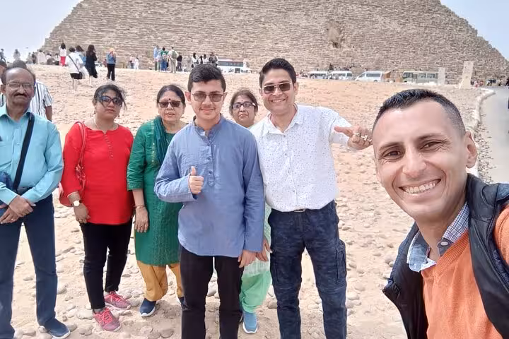 Group of tourists poses in front of the Great Pyramid, capturing memories on the Private 3 Days Tour in Egypt.
