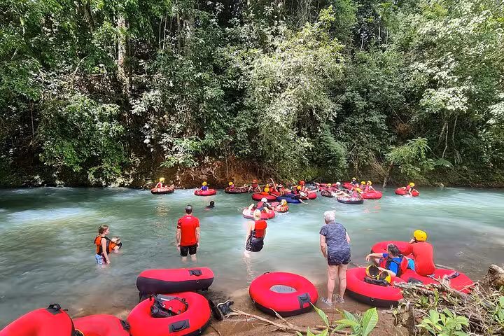 Group of tourists preparing for tubing adventure in Rio Celeste, immersing in the stunning natural beauty of Costa Rica.