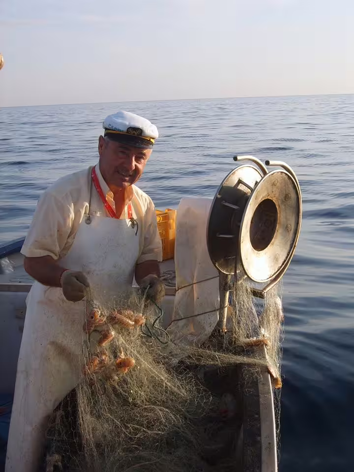 Local fisherman hauling a net with fresh catch on the Adriatic Sea, Trabocchi Coast fishing tourism experience